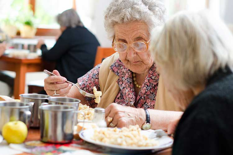 older adult in aged care facility requires meal assistance