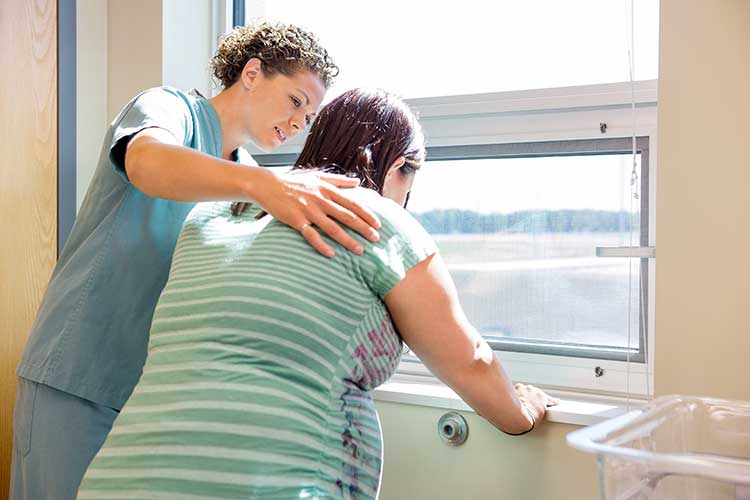 one-to-one support labour nurse comforting patient