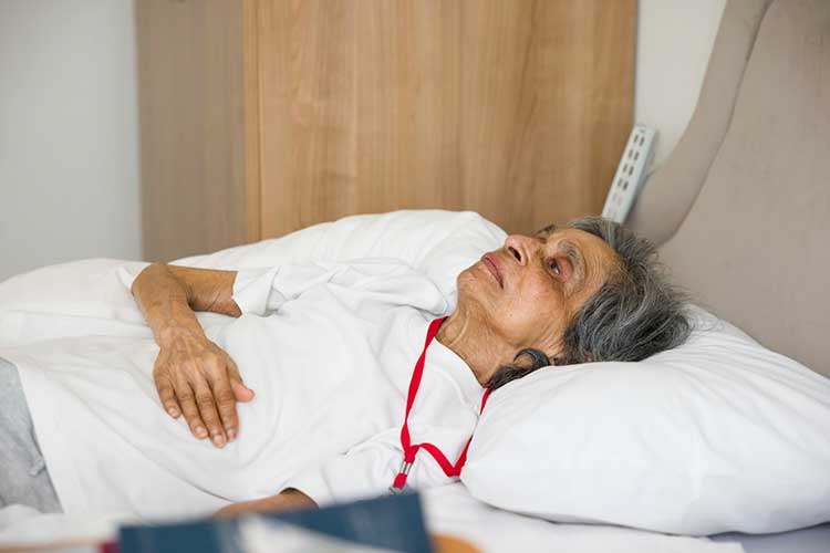 assessing frailty signs woman lying in bed