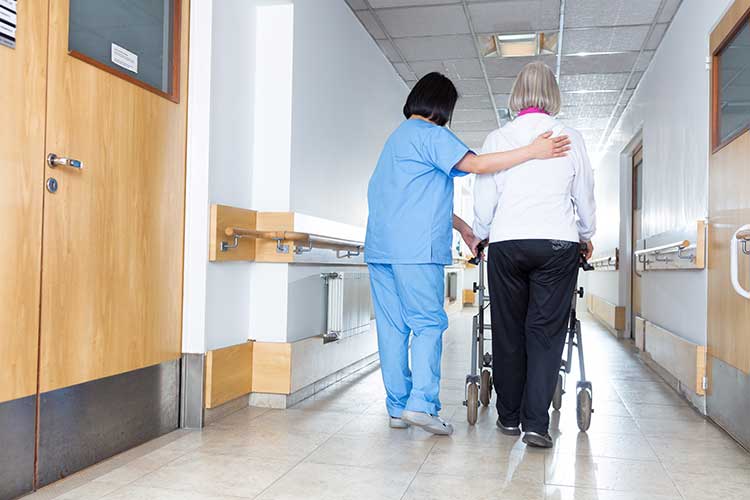 assessing frailty carer assisting older woman with mobilisation