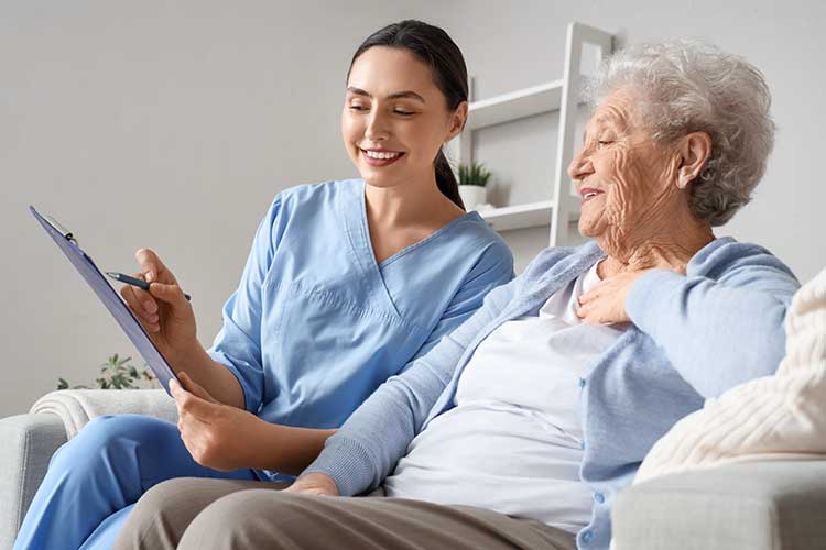 monthly care statements worker showing clipboard to older person