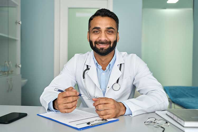clinical governance practitioner sitting at desk