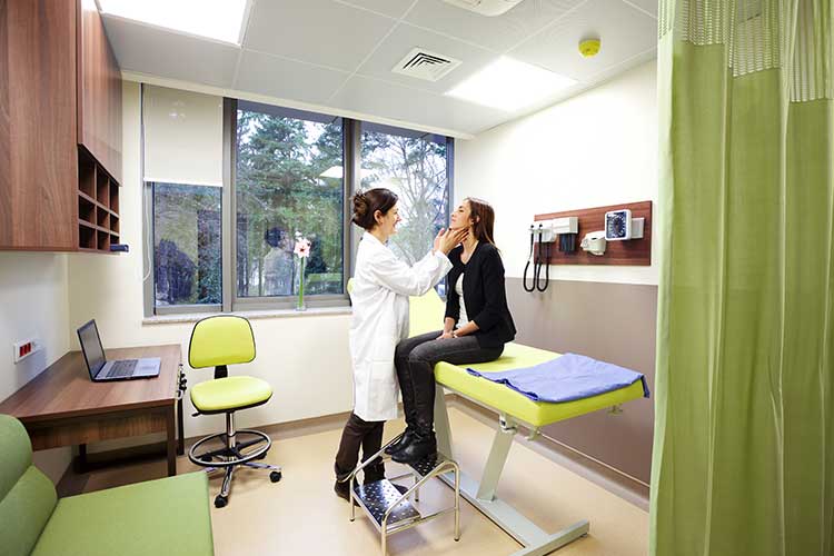 clinical safety practitioner assessing patient in clinic