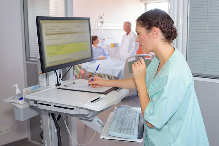 female health professional writing on clipboard on standing desk