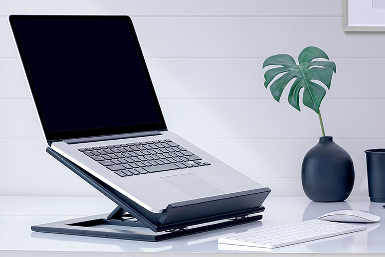 laptop on raised stand with external keyboard and mouse